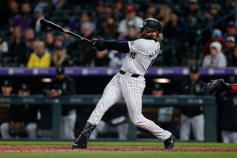 May 10, 2024; Denver, Colorado, USA; Colorado Rockies designated hitter Charlie Blackmon (19) hits a two RBI double in the eighth inning against the Texas Rangers at Coors Field. Mandatory Credit: Isaiah J. Downing-USA TODAY Sports