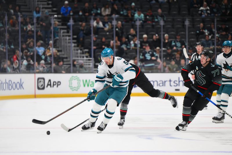 Nov 5, 2025; Seattle, Washington, USA; San Jose Sharks defenseman Vincent Desharnais (5) plays the puck during the third period against the Seattle Kraken at Climate Pledge Arena. Mandatory Credit: Steven Bisig-Imagn Images