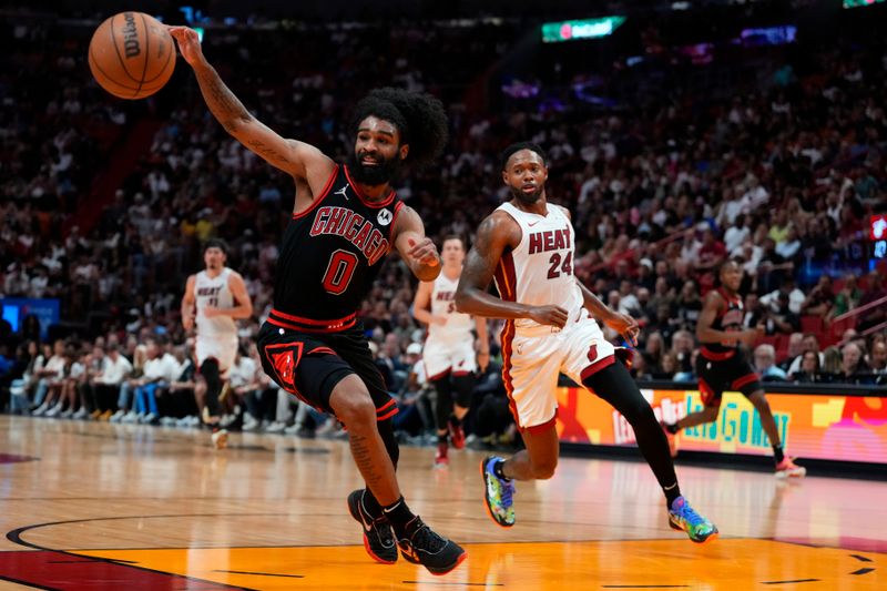 MIAMI, FLORIDA - APRIL 19: Coby White #0 of the Chicago Bulls dribbles the ball against Haywood Highsmith #24 of the Miami Heat in the fourth quarter during the Play-In Tournament at Kaseya Center on April 19, 2024 in Miami, Florida. NOTE TO USER: User expressly acknowledges and agrees that, by downloading and or using this photograph, User is consenting to the terms and conditions of the Getty Images License Agreement. (Photo by Rich Storry/Getty Images)