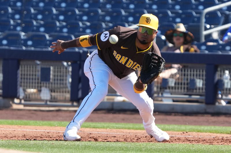 Feb 25, 2025; Peoria, Arizona, USA; San Diego Padres first baseman Luis Arraez (4) makes a play for an out against the Los Angeles Angels during the third inning at Peoria Sports Complex. Mandatory Credit: Rick Scuteri-Imagn Images