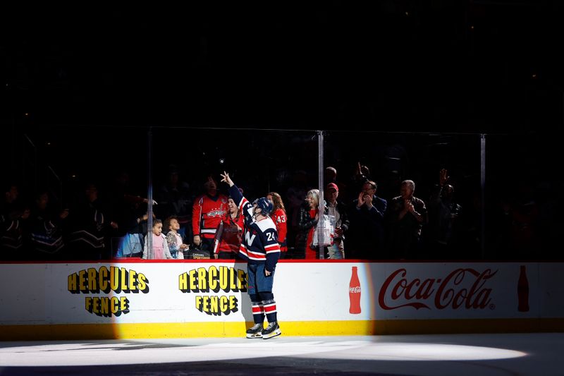 Feb 20, 2024; Washington, District of Columbia, USA; Washington Capitals center Connor McMichael (24) tosses a puck into the stands after being named number one star of the game against the New Jersey Devils at Capital One Arena. Mandatory Credit: Geoff Burke-USA TODAY Sports