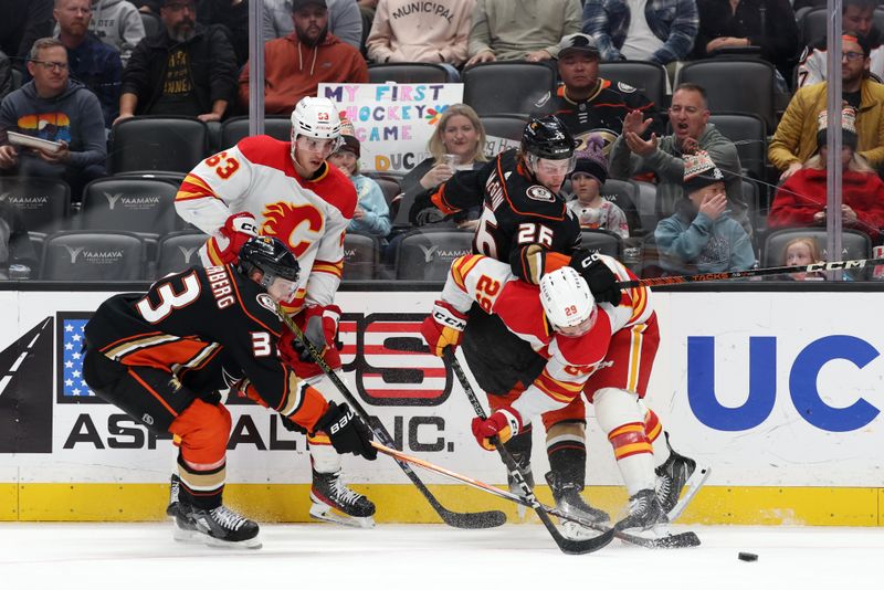 Dec 21, 2023; Anaheim, California, USA;  Anaheim Ducks left wing Brock McGinn (26) and right wing Jakob Silfverberg (33) fight for the puck against Calgary Flames center Adam Ruzicka (63) and center Dillon Dube (29) during the first period at Honda Center. Mandatory Credit: Kiyoshi Mio-USA TODAY Sports