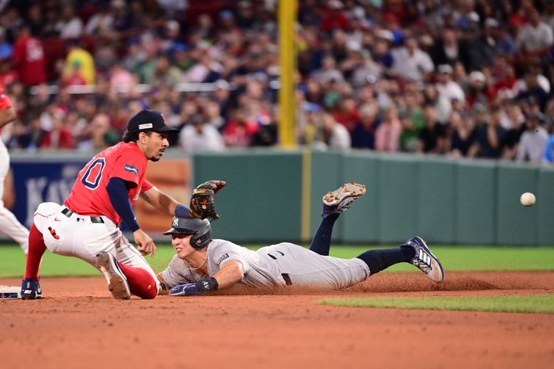 Jun 14, 2024; Boston, Massachusetts, USA; New York Yankees shortstop Anthony Volpe (11) steals second base  against Boston Red Sox shortstop David Hamilton (70) during the fifth inning at Fenway Park. Mandatory Credit: Eric Canha-USA TODAY Sports