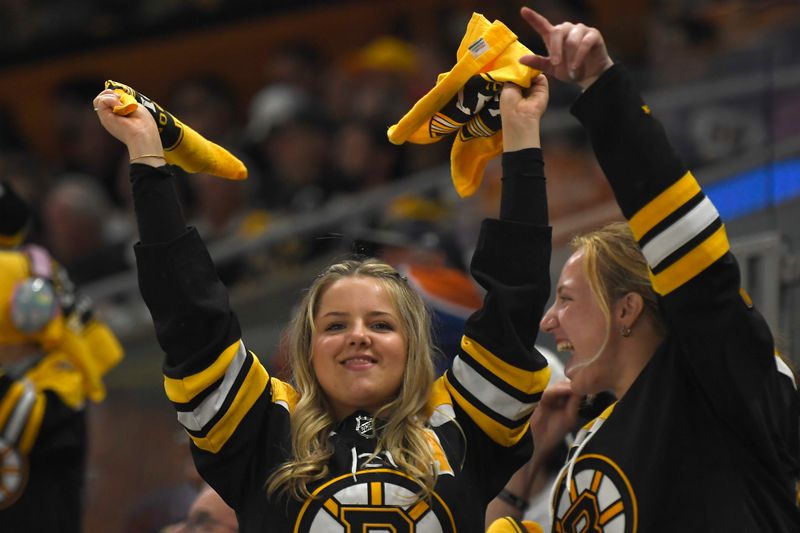 Apr 20, 2024; Boston, Massachusetts, USA; A fan waves towels during the second period in game one of the first round of the 2024 Stanley Cup Playoffs between the Boston Bruins and Toronto Maple Leafs at TD Garden. Mandatory Credit: Bob DeChiara-USA TODAY Sports