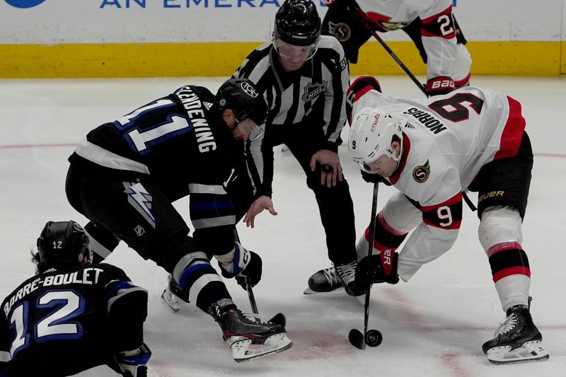 Feb 19, 2024; Tampa, Florida, USA; Tampa Bay Lightning center Luke Glendening (11) faces off Ottawa Senators center Josh Norris (9) for the puck during the first period at Amalie Arena. Mandatory Credit: Dave Nelson-USA TODAY Sports