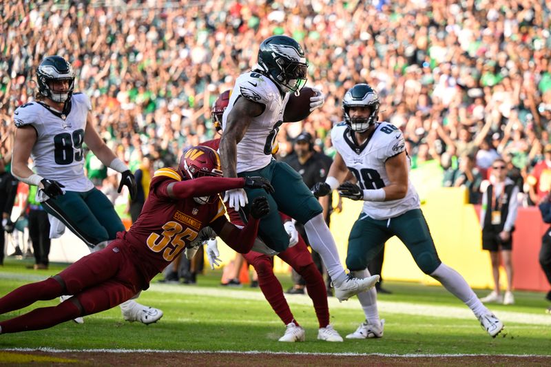 Philadelphia Eagles running back D'Andre Swift (0) runs the ball for a touchdown during the second half of an NFL football game against the Washington Commanders, Sunday, Oct. 29, 2023, in Landover, Md. (AP Photo/Terrance Williams)