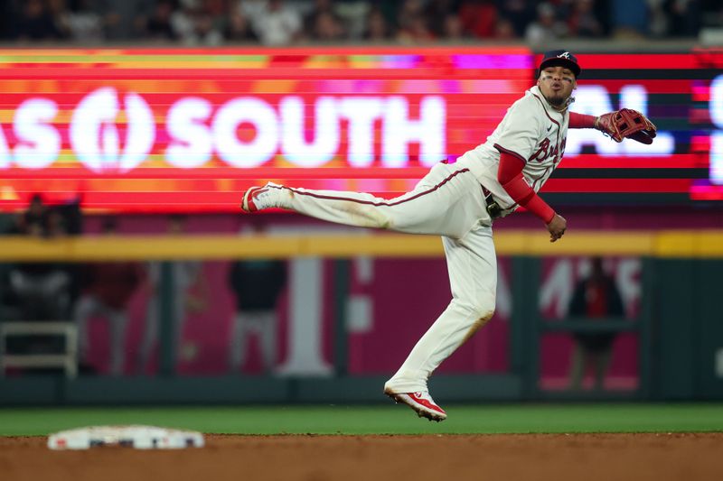 Apr 6, 2024; Atlanta, Georgia, USA; Atlanta Braves shortstop Orlando Arcia (11) throws a runner out at first against the Arizona Diamondbacks in the ninth inning at Truist Park. Mandatory Credit: Brett Davis-USA TODAY Sports
