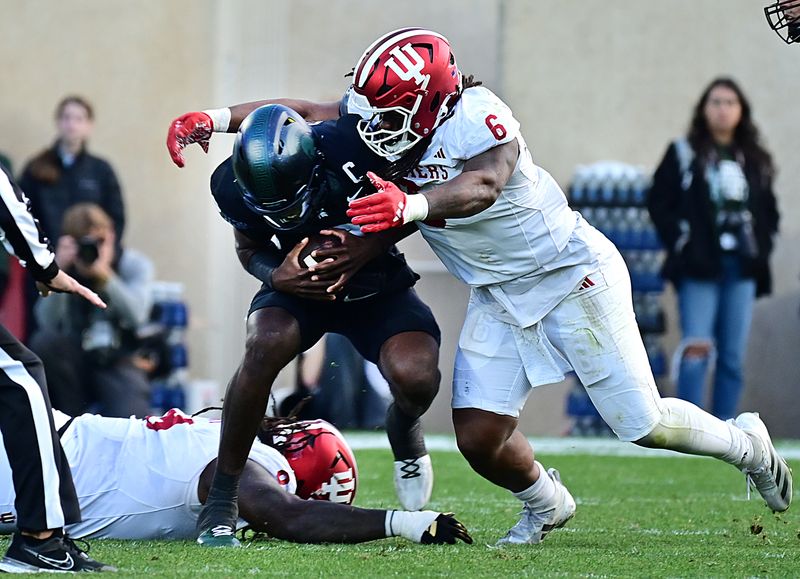 Nov 2, 2024; East Lansing, Michigan, USA;  Michigan State Spartans quarterback Aidan Chiles (2) gets sacked by Indiana Hoosiers defensive lineman Mikail Kamara (6) during the second quarter at Spartan Stadium. Mandatory Credit: Dale Young-Imagn Images