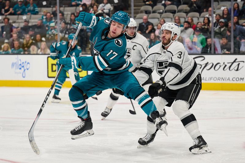 Apr 4, 2024; San Jose, California, USA; San Jose Sharks center Thomas Bordeleau (17) leaps to deflect a shot on goal against Los Angeles Kings defenseman Matt Roy (3) during the second period at SAP Center at San Jose. Mandatory Credit: Robert Edwards-USA TODAY Sports