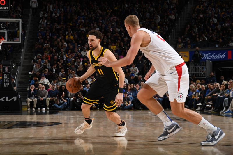 SAN FRANCISCO, CA - FEBRUARY 14: Klay Thompson #11 of the Golden State Warriors dribbles the ball during the game against the LA Clippers on FEBRUARY 14, 2024 at Chase Center in San Francisco, California. NOTE TO USER: User expressly acknowledges and agrees that, by downloading and or using this photograph, user is consenting to the terms and conditions of Getty Images License Agreement. Mandatory Copyright Notice: Copyright 2024 NBAE (Photo by Noah Graham/NBAE via Getty Images)