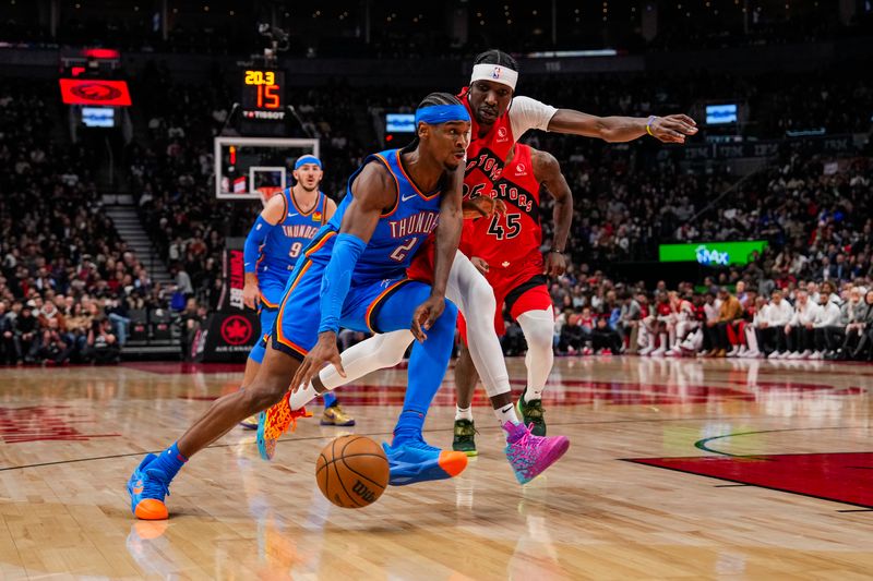 TORONTO, ON - DECEMBER 05: Shai Gilgeous-Alexander #2 of the Oklahoma City Thunder drives to the basket against Chris Boucher #25 of the Toronto Raptors at Scotiabank Arena on December 5, 2024 in Toronto, Ontario, Canada. NOTE TO USER: User expressly acknowledges and agrees that, by downloading and/or using this Photograph, user is consenting to the terms and conditions of the Getty Images License Agreement. (Photo by Andrew Lahodynskyj/Getty Images)