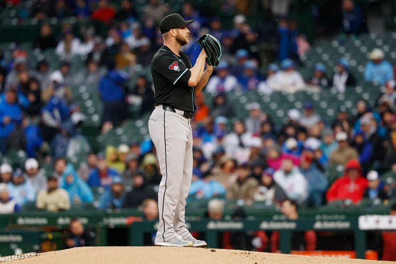 Apr 20, 2025; Chicago, Illinois, USA; Arizona Diamondbacks starting pitcher Merrill Kelly (29) settles before a pitch against the Chicago Cubs during the first inning at Wrigley Field. Mandatory Credit: Kamil Krzaczynski-Imagn Images