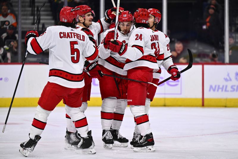 Nov 28, 2023; Philadelphia, Pennsylvania, USA; Carolina Hurricanes left wing Michael Bunting (58) celebrates with teammates after scoring a goal against the Philadelphia Flyers in the first period at Wells Fargo Center. Mandatory Credit: Kyle Ross-USA TODAY Sports