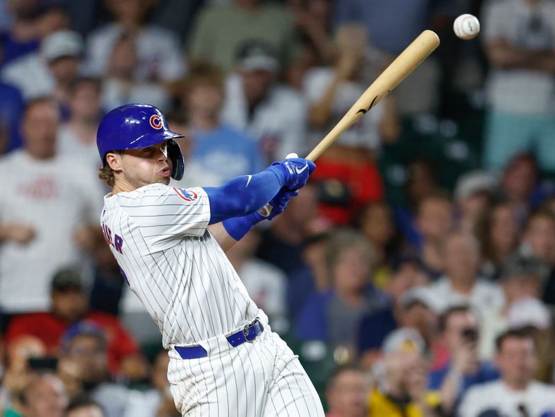 May 21, 2024; Chicago, Illinois, USA; Chicago Cubs second baseman Nico Hoerner (2) hits a game winning walk-off single against the Atlanta Braves during the 10th inning at Wrigley Field. Mandatory Credit: Kamil Krzaczynski-USA TODAY Sports