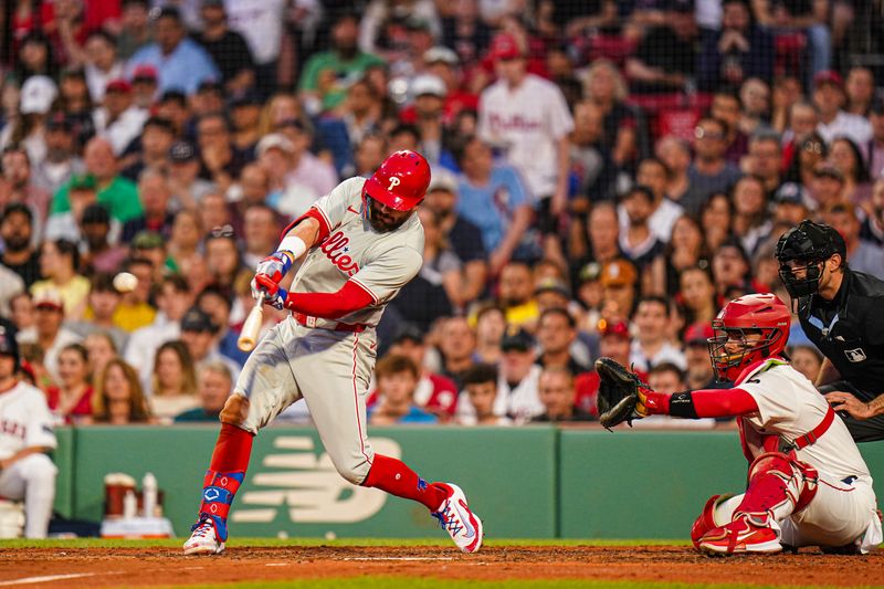 Jun 13, 2024; Boston, Massachusetts, USA; Philadelphia Phillies designated hitter Kyle Schwarber (12) hits a double to drive in three runs against the Boston Red Sox in the fourth inning at Fenway Park. Mandatory Credit: David Butler II-USA TODAY Sports