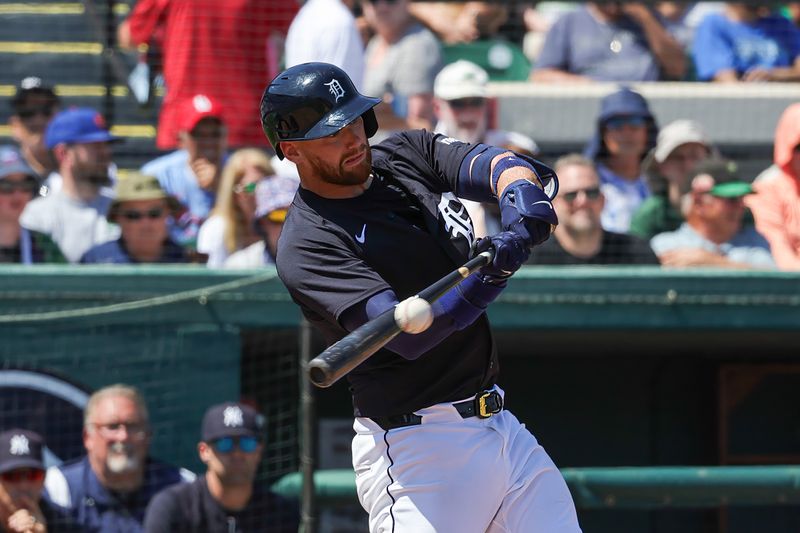 Mar 14, 2024; Lakeland, Florida, USA; Detroit Tigers catcher Carson Kelly (15) hits a single during the second inning against the New York Yankees at Publix Field at Joker Marchant Stadium. Mandatory Credit: Mike Watters-USA TODAY Sports