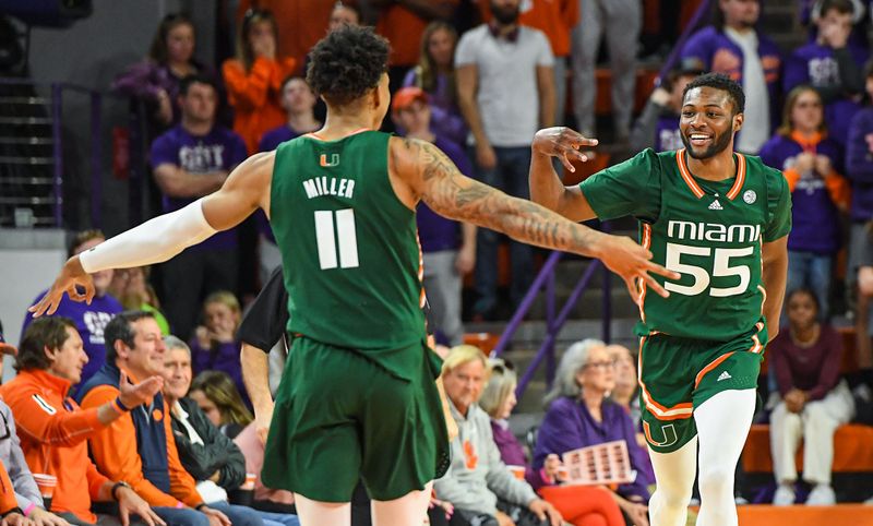 Feb 4, 2023; Clemson, South Carolina, USA; Miami guard Wooga Poplar (55) smiles with Miami guard Jordan Miller (11) after making a three-point shot late in the game with Clemson during the second half at Littlejohn Coliseum in Clemson, S.C. Saturday, Feb. 4, 2023.  Mandatory Credit: Ken Ruinard-USA TODAY Sports