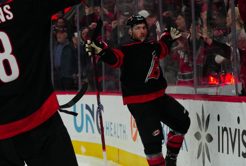 Jan 21, 2024; Raleigh, North Carolina, USA;  Carolina Hurricanes left wing Michael Bunting (58) celebrates his goal against the Minnesota Wild during the third period at PNC Arena. Mandatory Credit: James Guillory-USA TODAY Sports