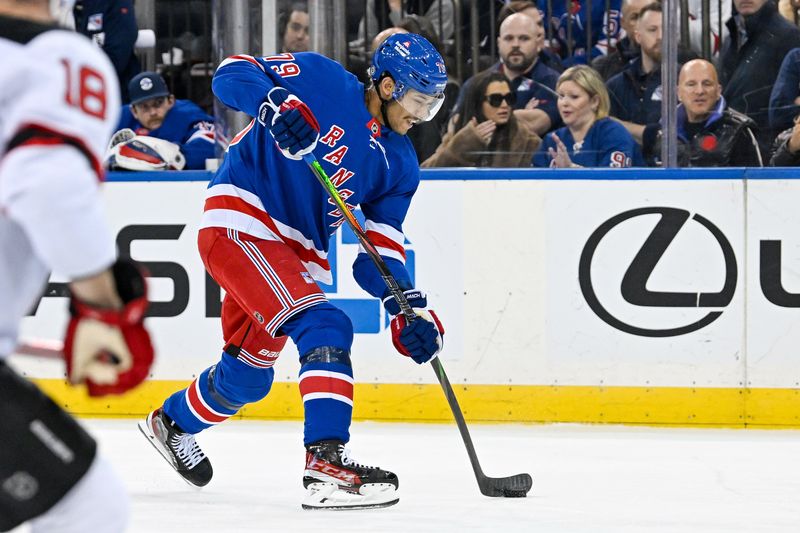 Dec 2, 2024; New York, New York, USA;  New York Rangers defenseman K'Andre Miller (79) shoots the puck against the New Jersey Devils during the second period at Madison Square Garden. Mandatory Credit: Dennis Schneidler-Imagn Images