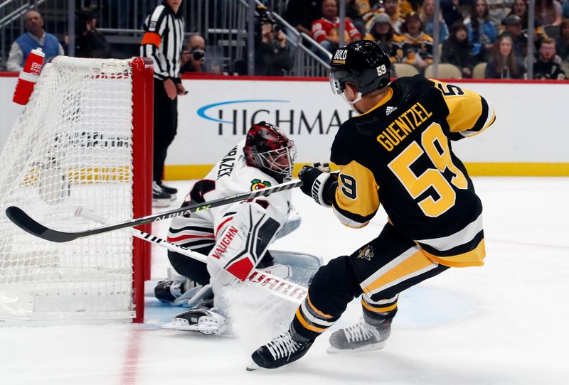 Oct 10, 2023; Pittsburgh, Pennsylvania, USA; Chicago Blackhawks goaltender Petr Mrazek (34) makes a save against Pittsburgh Penguins left wing Jake Guentzel (59) during the first period at the PPG Paints Arena. Mandatory Credit: Charles LeClaire-USA TODAY Sports