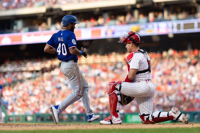 May 21, 2024; Philadelphia, Pennsylvania, USA; Texas Rangers outfielder Derek Hill (40) scores in front of Philadelphia Phillies catcher J.T. Realmuto (10) during the third inning at Citizens Bank Park. Mandatory Credit: Bill Streicher-USA TODAY Sports