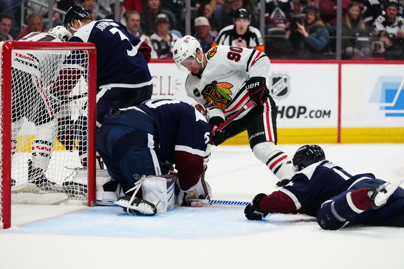 Mar 4, 2024; Denver, Colorado, USA; Chicago Blackhawks center Tyler Johnson (90) attempts to score on  Colorado Avalanche goaltender Justus Annunen (60) and right wing Chris Wagner (14) in the third period at Ball Arena. Mandatory Credit: Ron Chenoy-USA TODAY Sports