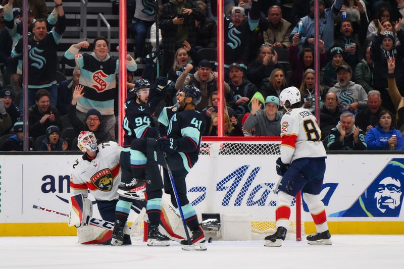 Dec 12, 2023; Seattle, Washington, USA; Seattle Kraken center Devin Shore (94) and left wing Pierre-Edouard Bellemare (41) celebrate after Bellemare scored a goal against the Florida Panthers during the third period at Climate Pledge Arena. Mandatory Credit: Steven Bisig-USA TODAY Sports