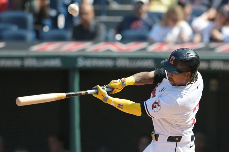 Sep 15, 2024; Cleveland, Ohio, USA; Cleveland Guardians designated hitter Jose Ramirez (11) hits a double during the first inning against the Tampa Bay Rays at Progressive Field. Mandatory Credit: Ken Blaze-Imagn Images