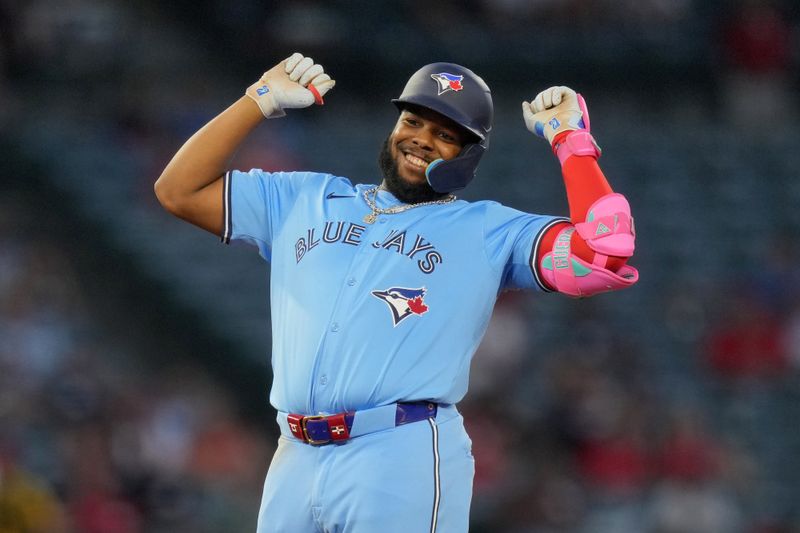 Aug 14, 2024; Anaheim, California, USA; Toronto Blue Jays first baseman Vladimir Guerrero Jr. (27) celebrates after hitting a double in the fifth inning against the Los Angeles Angels at Angel Stadium. Mandatory Credit: Kirby Lee-USA TODAY Sports