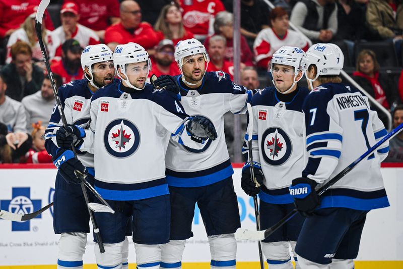 Oct 30, 2024; Detroit, Michigan, USA; Winnipeg Jets defenseman Neal Pink (4) celebrates his goal during the third period against the Detroit Red Wings at Little Caesars Arena. Mandatory Credit: Tim Fuller-Imagn Images