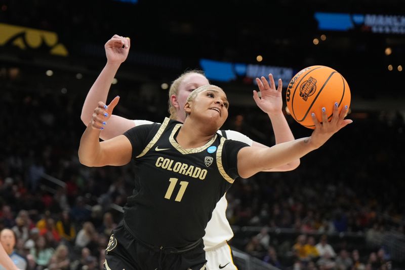 Mar 24, 2023; Seattle, WA, USA; Colorado Buffaloes center Quay Miller (11) reaches for the ball against Iowa Hawkeyes forward Addison O'Grady (44) in the second half at Climate Pledge Arena. Mandatory Credit: Kirby Lee-USA TODAY Sports