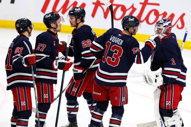 Oct 20, 2024; Winnipeg, Manitoba, CAN; Winnipeg Jets celebrate their victory over the Pittsburgh Penguins at Canada Life Centre. Mandatory Credit: James Carey Lauder-Imagn Images