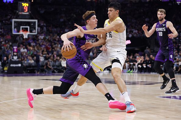 SACRAMENTO, CALIFORNIA - DECEMBER 16: Kevin Huerter #9 of the Sacramento Kings is guarded by Simone Fontecchio #16 of the Utah Jazz in the third quarter at Golden 1 Center on December 16, 2023 in Sacramento, California. NOTE TO USER: User expressly acknowledges and agrees that, by downloading and or using this photograph, User is consenting to the terms and conditions of the Getty Images License Agreement. (Photo by Lachlan Cunningham/Getty Images)