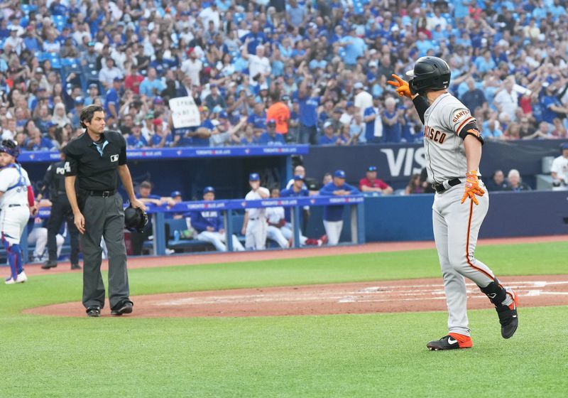 Jun 29, 2023; Toronto, Ontario, CAN; San Francisco Giants third baseman J.D. Davis (7) argues with the home plate umpire after being called out on strikes against the Toronto Blue Jays during the third inning at Rogers Centre. Mandatory Credit: Nick Turchiaro-USA TODAY Sports