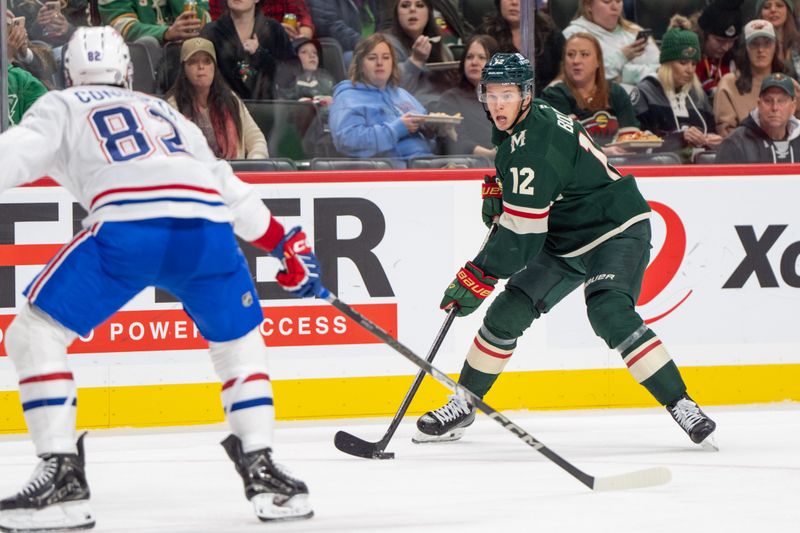 Nov 14, 2024; Saint Paul, Minnesota, USA; Minnesota Wild left wing Matt Boldy (12) looks to pass as Montreal Canadiens left wing Lucas Condotta (82) defends in the second period at Xcel Energy Center. Mandatory Credit: Matt Blewett-Imagn Images