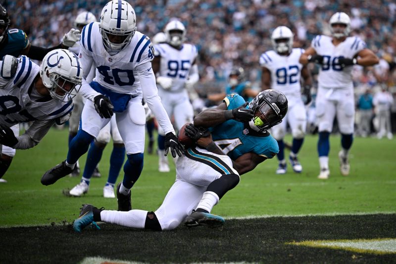 Jacksonville Jaguars running back Tank Bigsby (4) goes in for a touchdown during the second half of an NFL football game against the Indianapolis Colts, Sunday, Oct. 6, 2024, in Jacksonville, Fla. (AP Photo/Phelan M. Ebenhack)