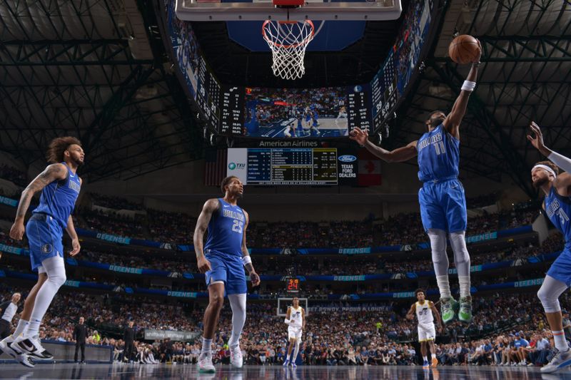 DALLAS, TX - OCTOBER 28: Kyrie Irving #11 of the Dallas Mavericks rebounds the ball during the game against the Utah Jazz on October 28, 2024 at American Airlines Center in Dallas, Texas. NOTE TO USER: User expressly acknowledges and agrees that, by downloading and or using this photograph, User is consenting to the terms and conditions of the Getty Images License Agreement. Mandatory Copyright Notice: Copyright 2024 NBAE (Photo by Glenn James/NBAE via Getty Images)