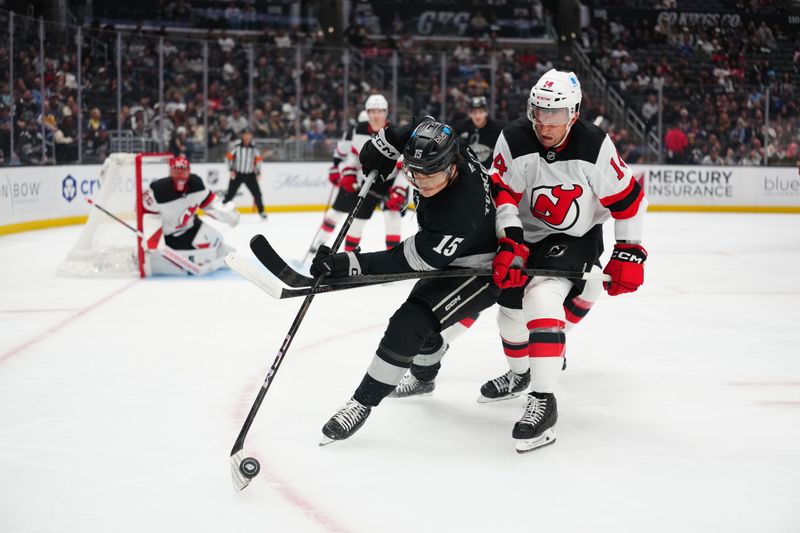 Nov 1, 2025; Los Angeles, California, USA; Los Angeles Kings center Alex Turcotte (15) and New Jersey Devils center Luke Glendening (14) battle for the puck in the second period at Crypto.com Arena. Mandatory Credit: Kirby Lee-Imagn Images