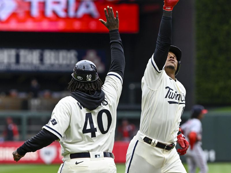 Apr 23, 2023; Minneapolis, Minnesota, USA;  Minnesota Twins infielder Jorge Polanco (11) celebrates his solo home run against the Washington Nationals with third base coach Tommy Watkins (40) during the fourth inning at Target Field. Mandatory Credit: Nick Wosika-USA TODAY Sports