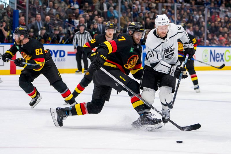 Mar 25, 2024; Vancouver, British Columbia, CAN; Vancouver Canucks defenseman Carson Soucy (7) checks Los Angeles Kings forward Trevor Lewis (61) in the second period at Rogers Arena. Mandatory Credit: Bob Frid-USA TODAY Sports