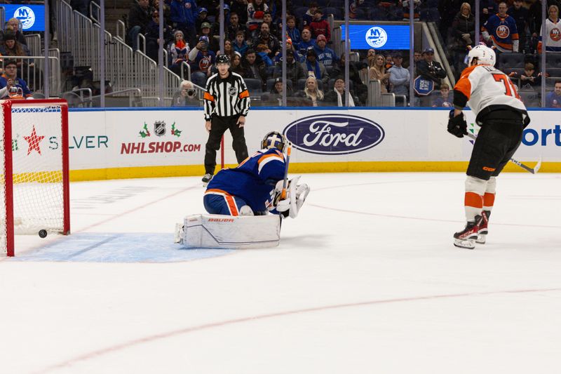 Nov 25, 2023; Elmont, New York, USA; Philadelphia Flyers right wing Tyson Foerster (71) scores the winning shot against the New York Islanders during the overtime shootout at UBS Arena. Mandatory Credit: Thomas Salus-USA TODAY Sports