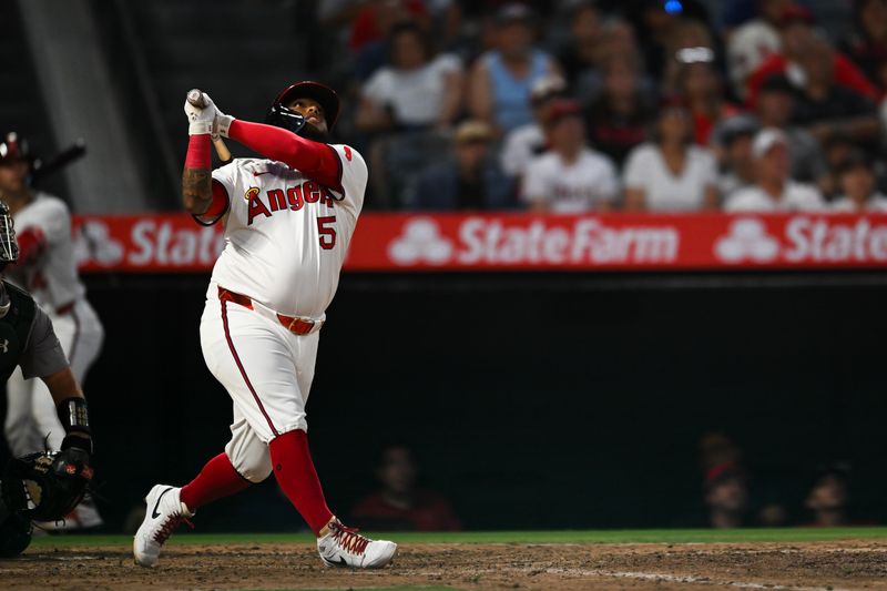 Jul 27, 2024; Anaheim, California, USA; Los Angeles Angels designated hitter Willie Calhoun (5) flies out against the Oakland Athletics during the sixth inning at Angel Stadium. Mandatory Credit: Jonathan Hui-USA TODAY Sports