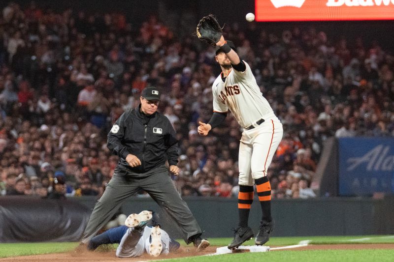 Jul 3, 2023; San Francisco, California, USA;  Seattle Mariners second baseman Jose Caballero (76) dives back to third base during the ninth inning against San Francisco Giants third baseman J.D. Davis (7) at Oracle Park. Mandatory Credit: Stan Szeto-USA TODAY Sports