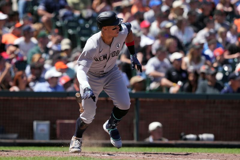 Jun 2, 2024; San Francisco, California, USA; New York Yankees center fielder Aaron Judge (99) runs to first base after hitting a single against the San Francisco Giants during the seventh inning at Oracle Park. Mandatory Credit: Darren Yamashita-USA TODAY Sports