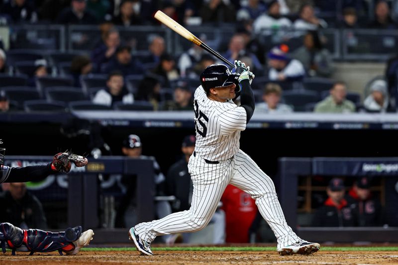 Oct 15, 2024; Bronx, New York, USA; New York Yankees second base Gleyber Torres (25) hits a single during the fourth inning in game two of the ALCS for the 2024 MLB Playoffs at Yankee Stadium. Mandatory Credit: Wendell Cruz-Imagn Images