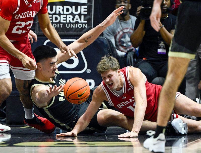 Feb 25, 2023; West Lafayette, Indiana, USA; Purdue Boilermakers center Zach Edey (15) and Indiana Hoosiers forward Miller Kopp (12) battle for a loose ball during the first half at Mackey Arena. Mandatory Credit: Marc Lebryk-USA TODAY Sports