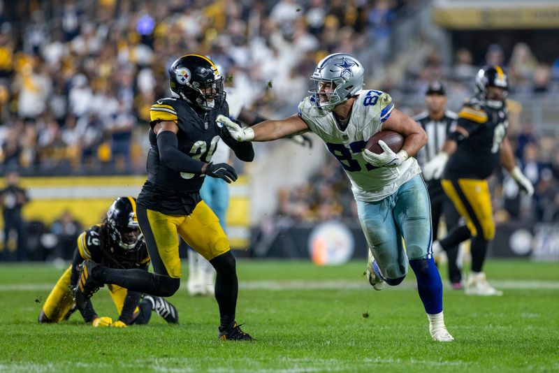 Dallas Cowboys tight end Jake Ferguson (87) stiff arms Pittsburgh Steelers safety Minkah Fitzpatrick (39) during an NFL football game, Sunday, Oct. 6, 2024, in Pittsburgh. (AP Photo/Matt Durisko)