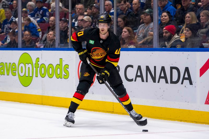 Oct 26, 2024; Vancouver, British Columbia, CAN; Vancouver Canucks forward Elias Pettersson (40) handles the puck against the Pittsburgh Penguins during the first period at Rogers Arena. Mandatory Credit: Bob Frid-Imagn Images