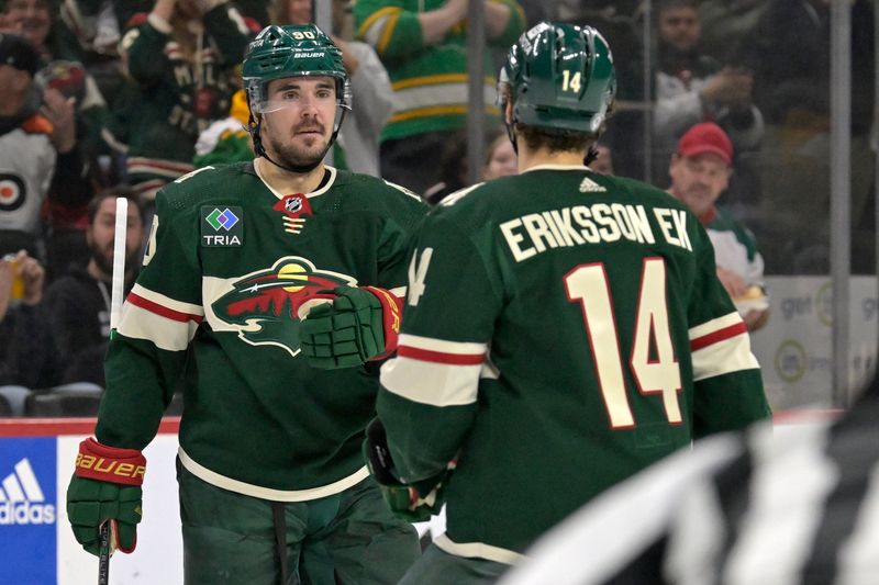 Jan 12, 2024; Saint Paul, Minnesota, USA; Minnesota Wild forward Marcus Johansson (90) celebrates his goal against the Philadelphia Flyers with forward Joel Eriksson Ek (14) during the second period at Xcel Energy Center. Mandatory Credit: Nick Wosika-USA TODAY Sports