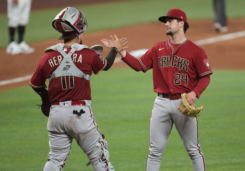 Apr 16, 2023; Miami, Florida, USA; Arizona Diamondbacks relief pitcher Kyle Nelson (24) is congratulated by Arizona Diamondbacks catcher Jose Herrera (11) after a 5-0 victory over the Miami Marlins at loanDepot Park. Mandatory Credit: Jim Rassol-USA TODAY Sports